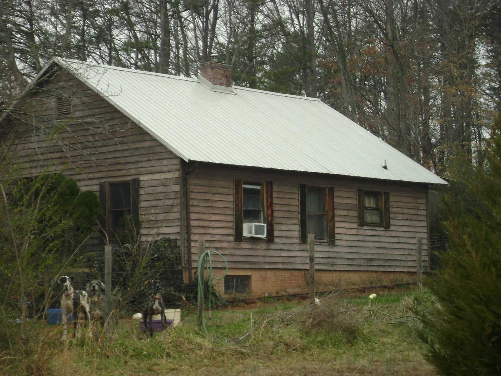 White metal roof on an old wood sided farmhouse, from a Metal Roof Installation job in Robesonia